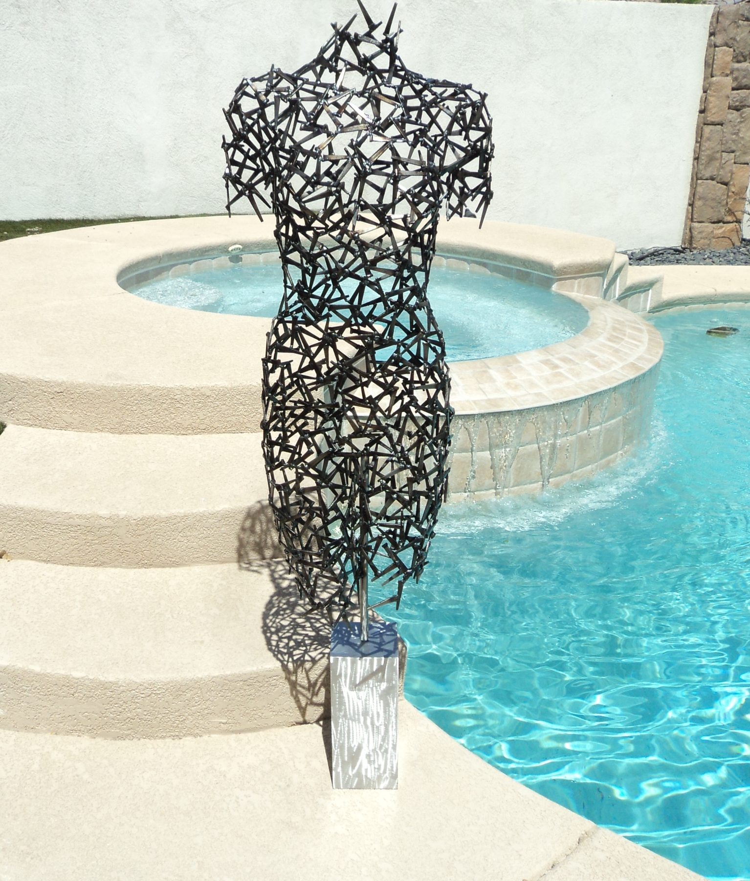 Figurative welded metal sculpture in the studio