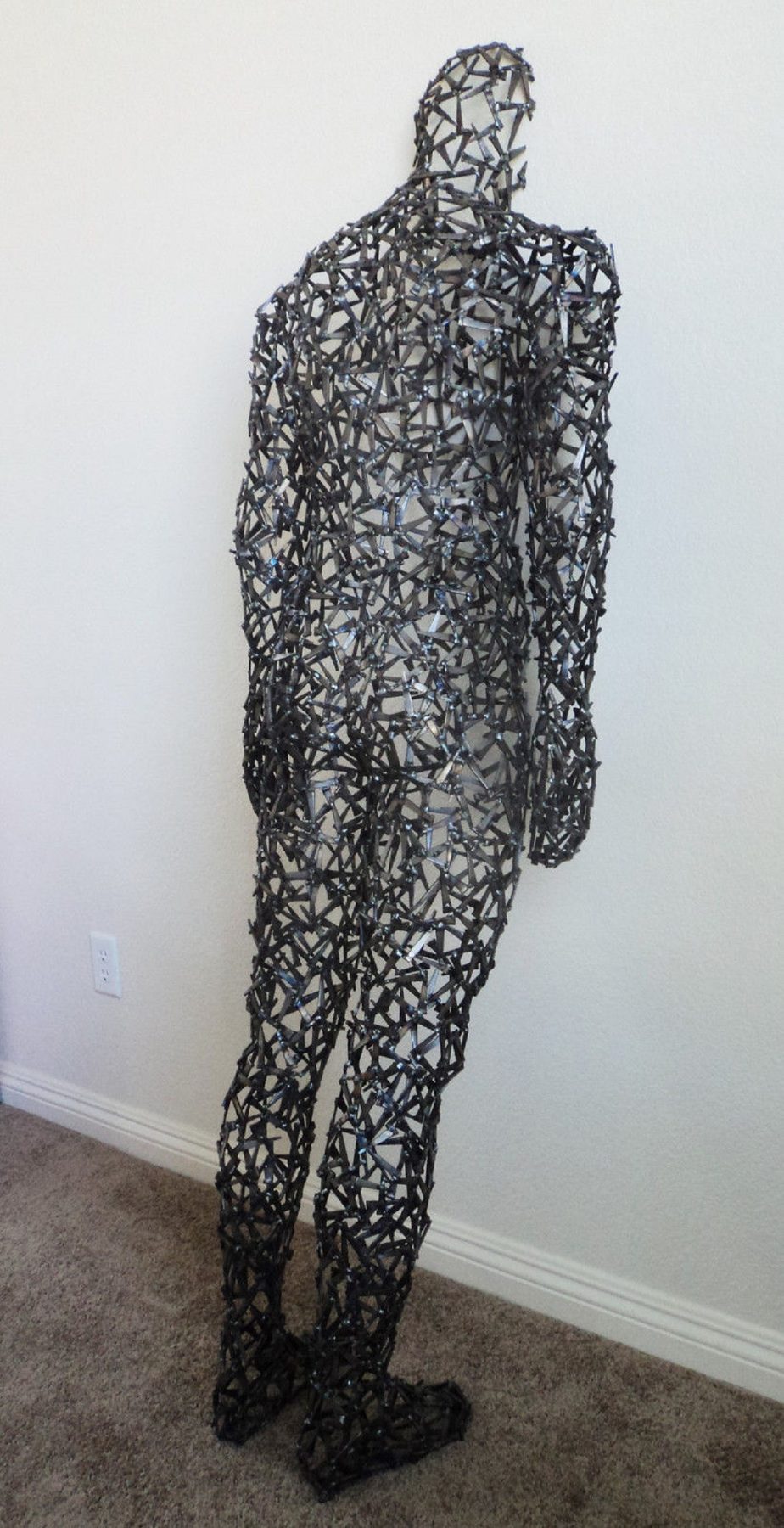 Looking In - figurative welded metal sculpture by Corey Ellis