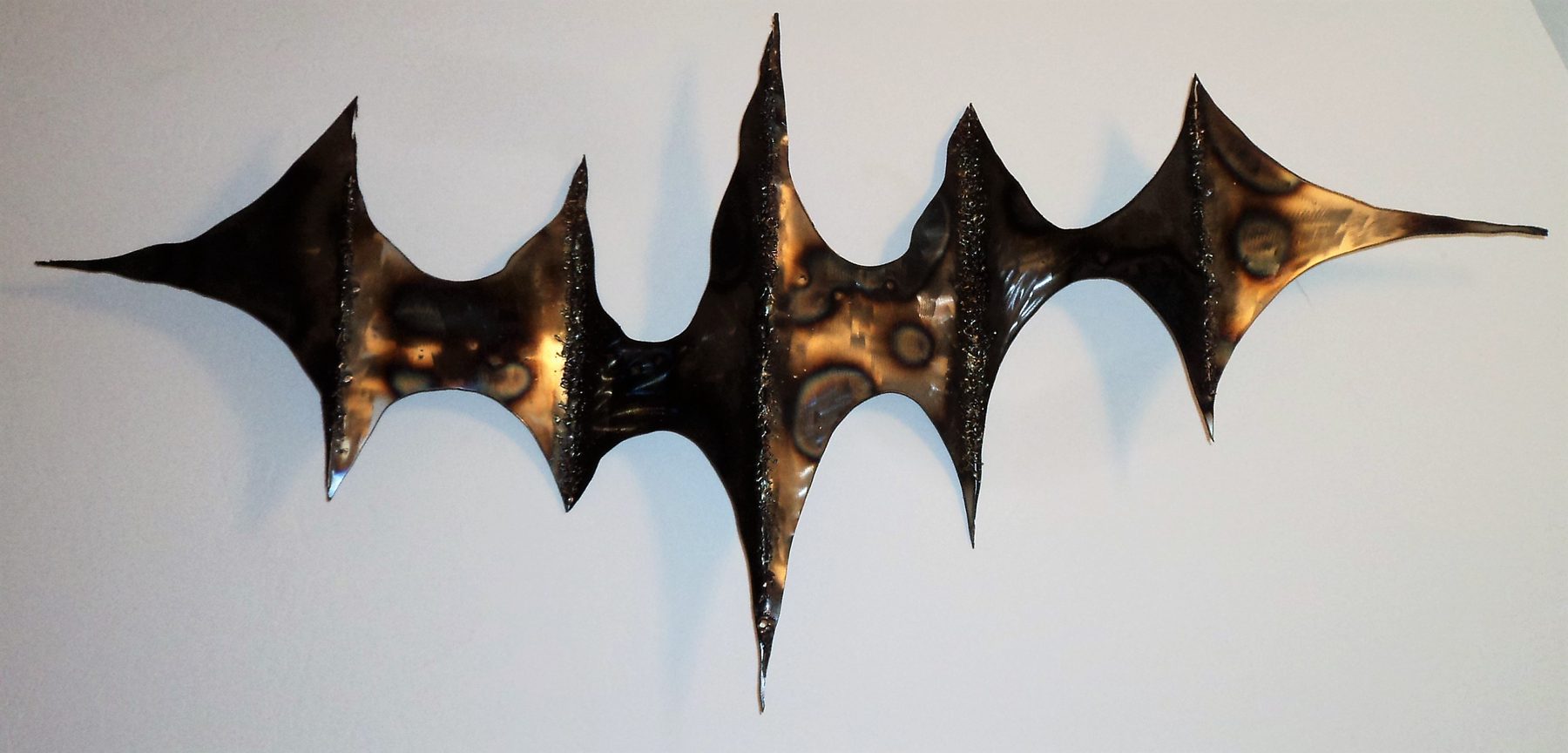 Brutalist welded metal wall sculpture with heavy nail texture