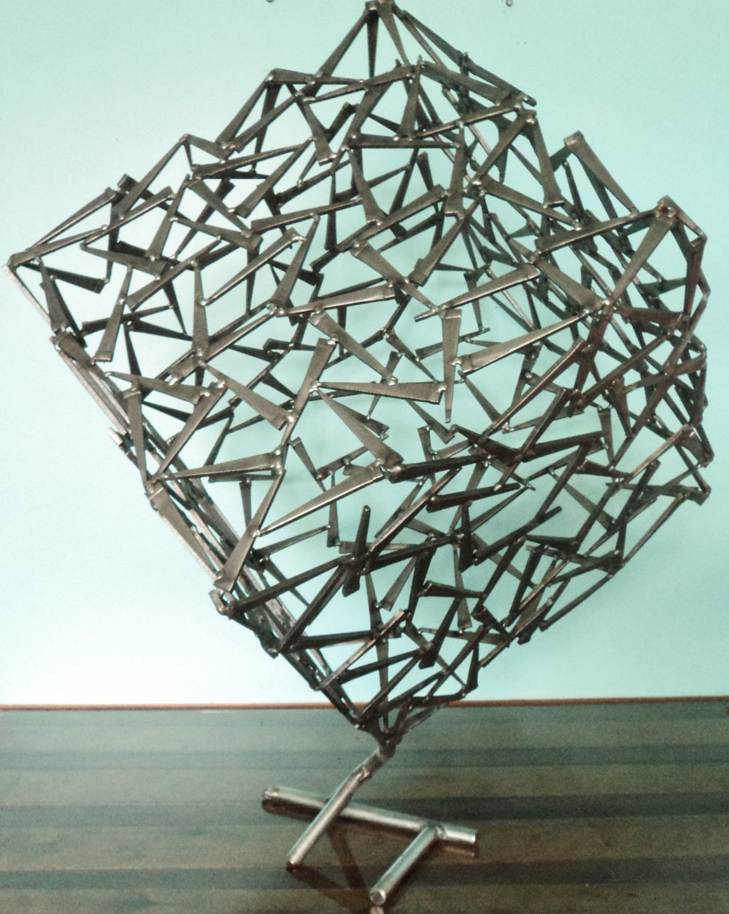 Geometric welded metal sculpture with sharp angular forms