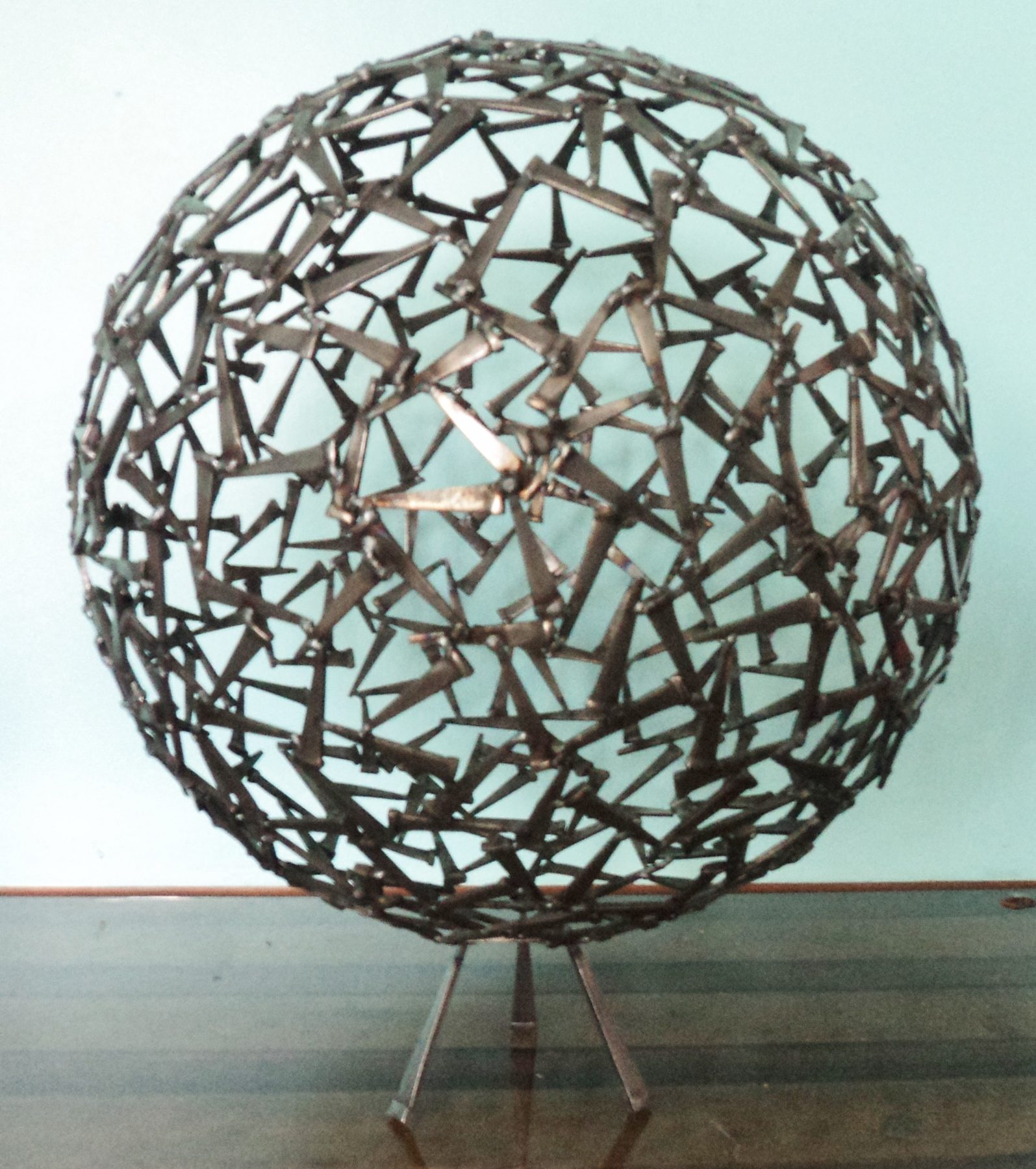 Geometric welded metal wall sculpture by Corey Ellis