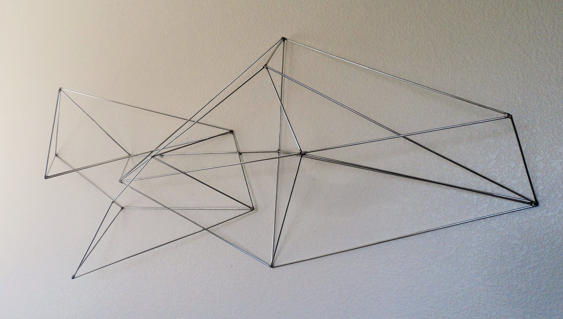 Geometric welded steel wall sculpture
