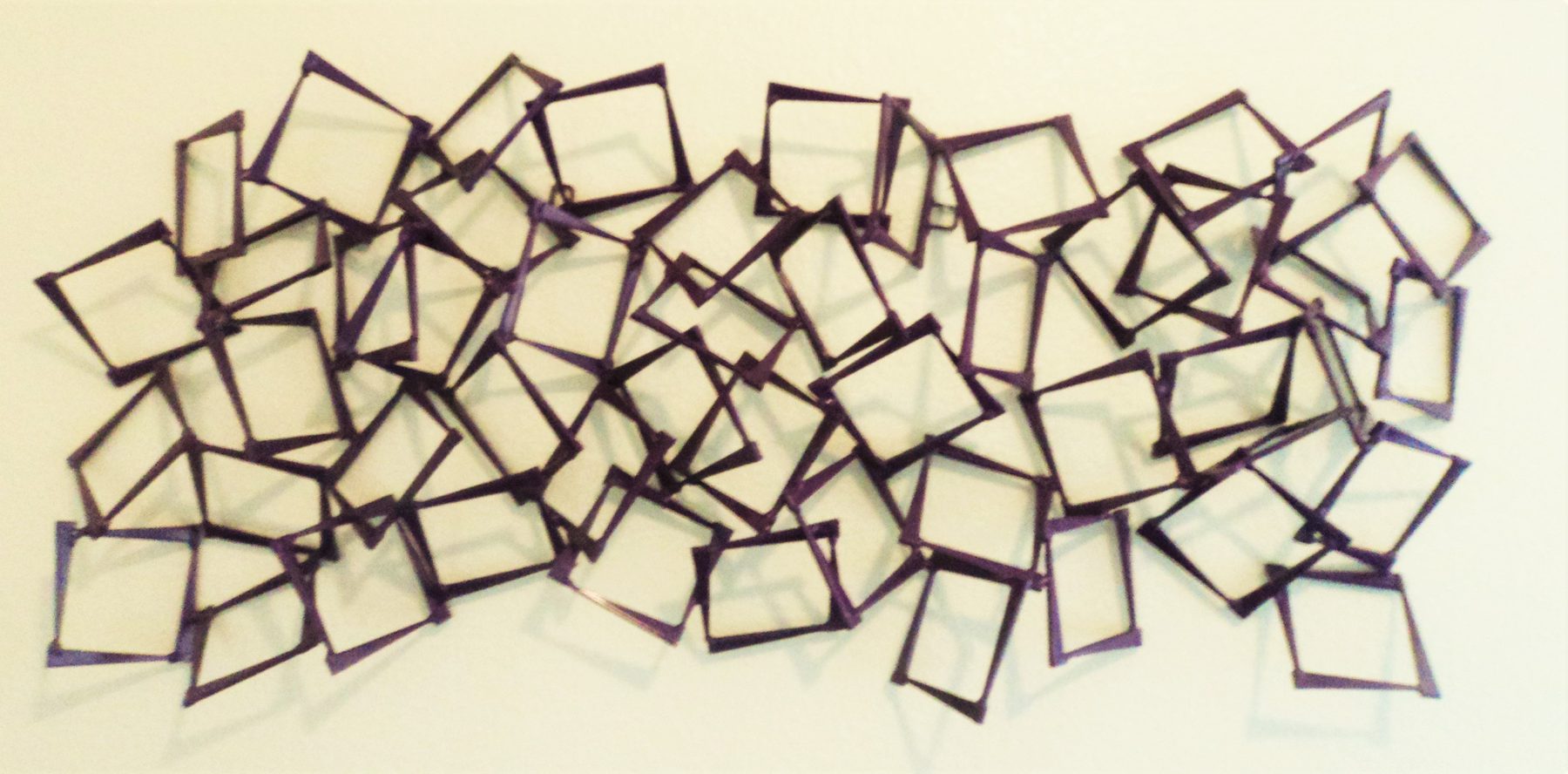 Layered geometric metal wall sculpture by Corey Ellis