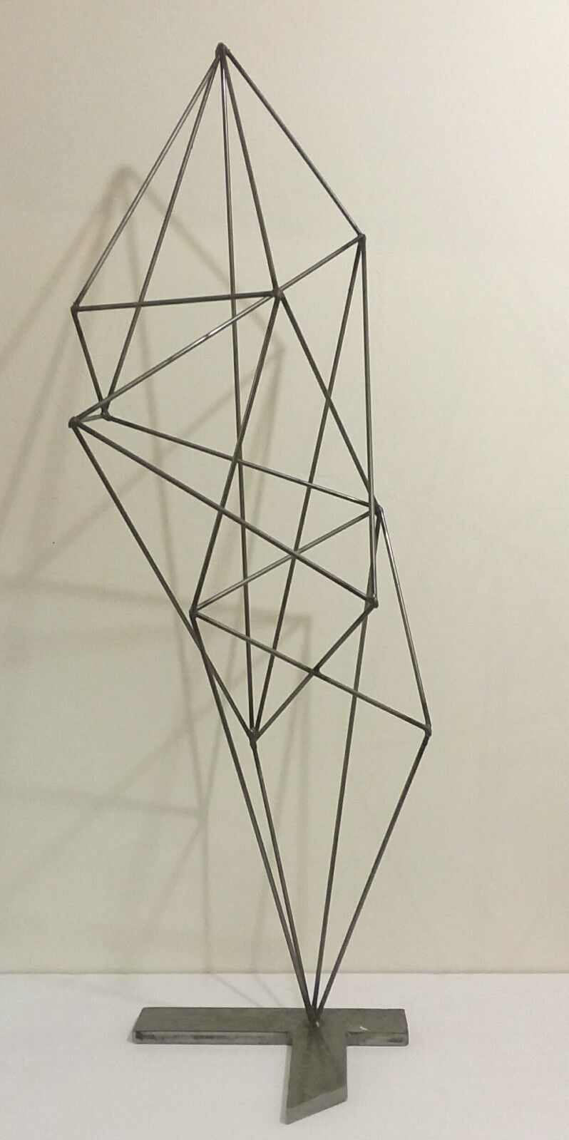Geometric welded metal wall sculpture by Corey Ellis
