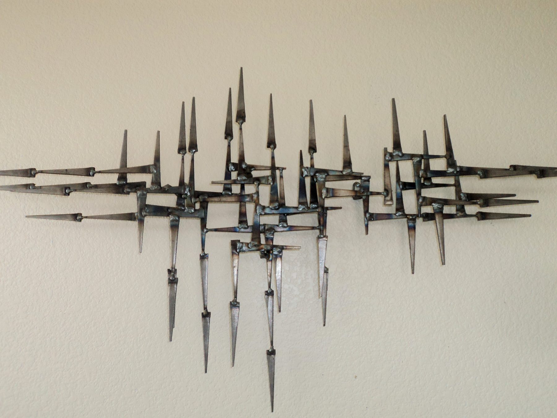 Mid-century brass and steel wall sculpture