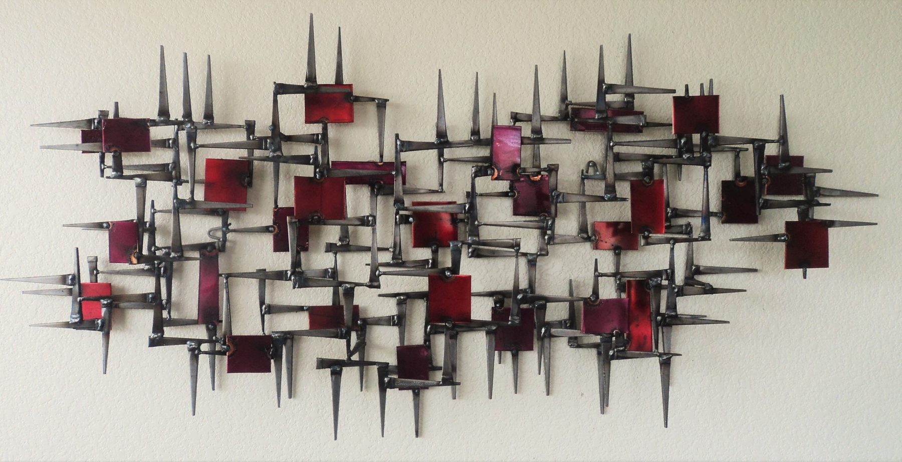 Red enameled mid-century metal wall sculpture by Corey Ellis