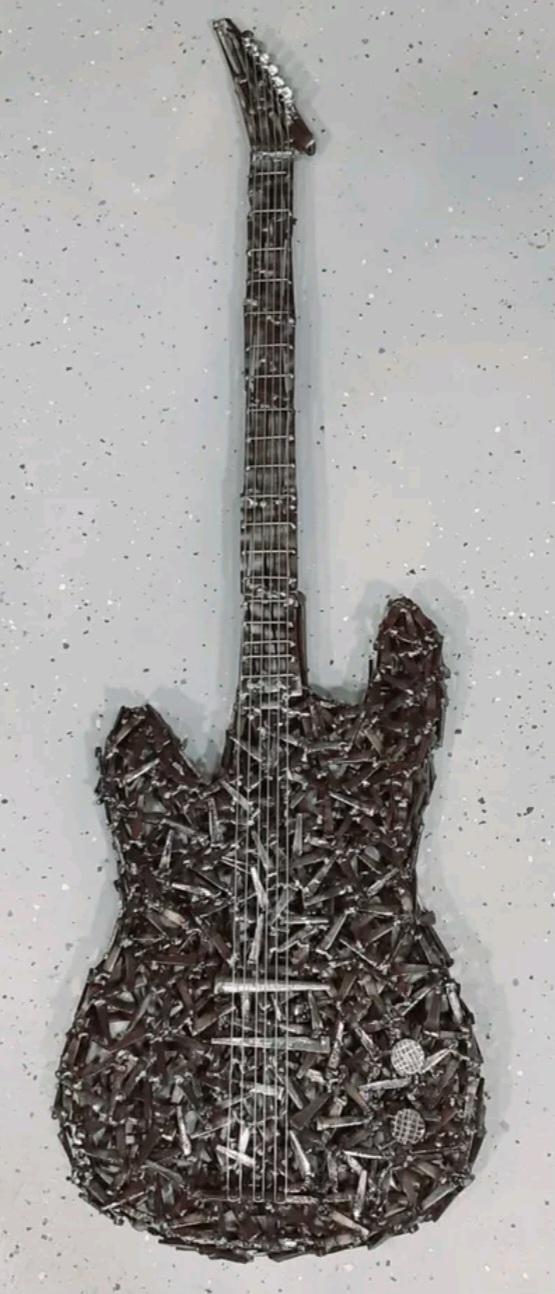 Music-themed welded metal wall sculpture by Corey Ellis